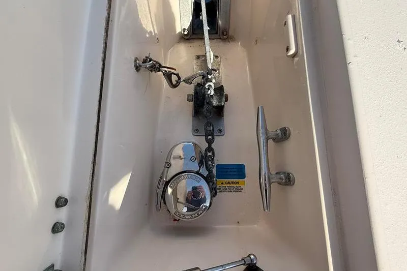Slide: The Image of Anchor compartment of 2007 Grady-White Bimini 306 boat with chain and cleat. - 36
