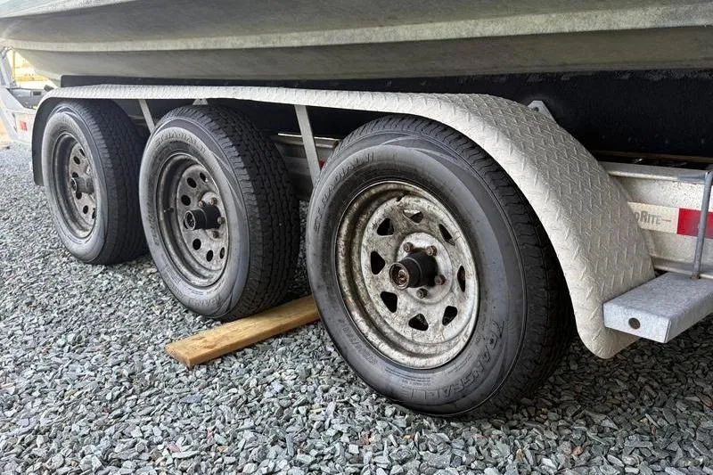 Slide: The Image of Trailer wheels of a 2007 Grady-White Bimini 306 boat on gravel. - 42