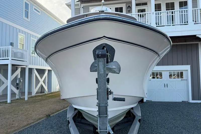 Slide: The Image of 2007 Grady-White Bimini 306 boat on trailer, parked in front of coastal home. - 7