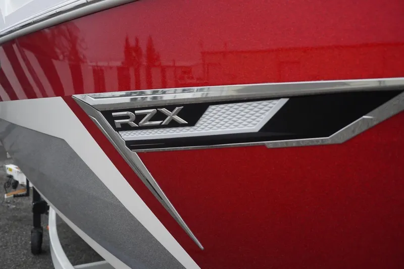 Slide: The Image of Red 2022 Tigé 22RZX boat with sleek RZX emblem detail. - 12