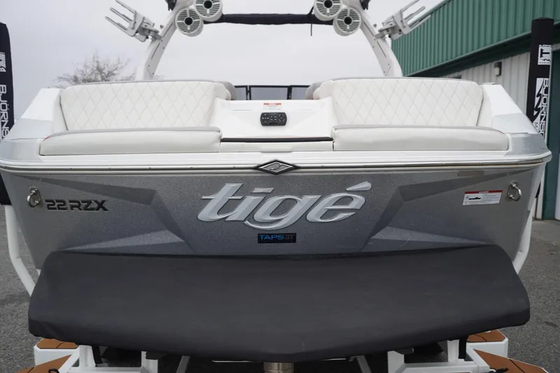 Slide: The Image of 2022 Tigé 22RZX boat rear view with white seating and logo. - 14