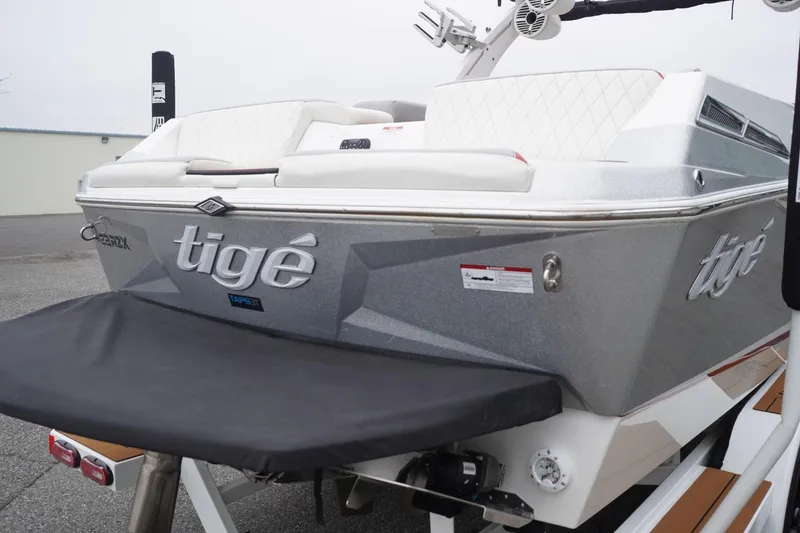 Slide: The Image of 2022 Tigé 22RZX boat rear view with sleek design and white seating. - 15
