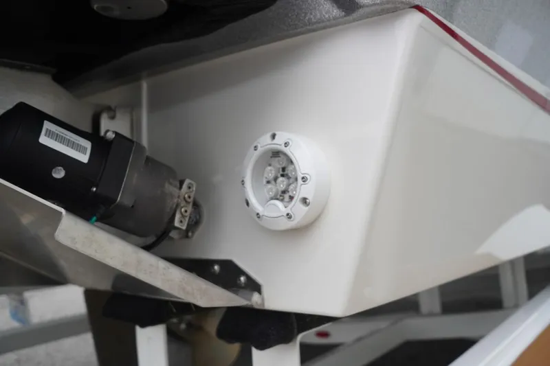 Slide: The Image of 2022 Tigé 22RZX boat detail showing underwater light and motor component. - 16