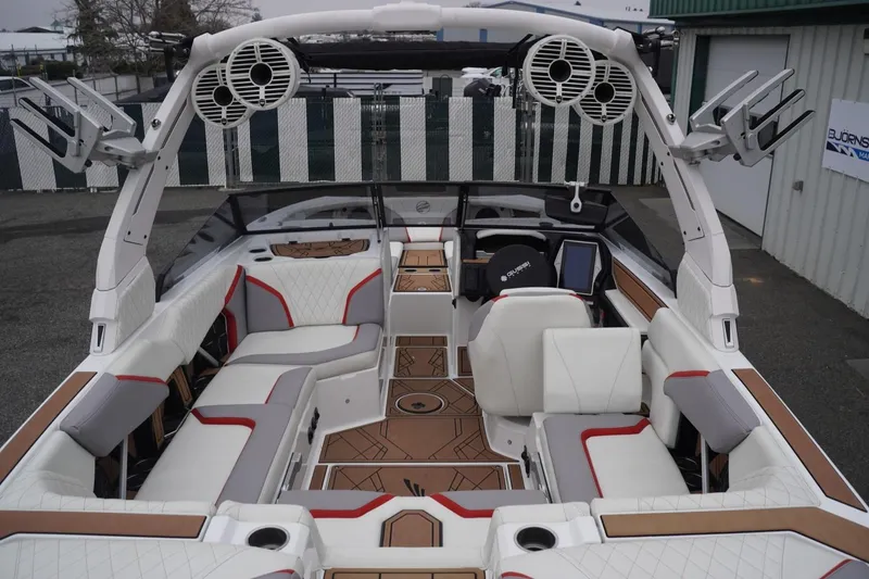 Slide: The Image of 2022 Tigé 22RZX boat interior with white and red seating, advanced audio system. - 18