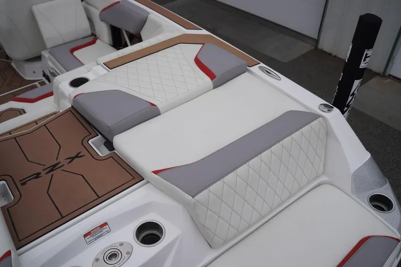 Slide: The Image of 2022 Tigé 22RZX boat interior with white and gray diamond-stitched seating. - 20