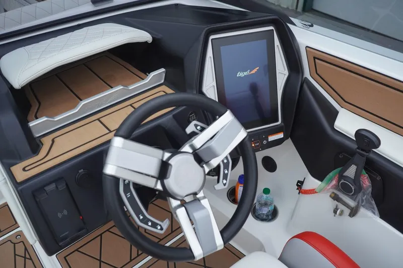 Slide: The Image of 2022 Tigé 22RZX boat dashboard with touchscreen and modern steering wheel. - 32