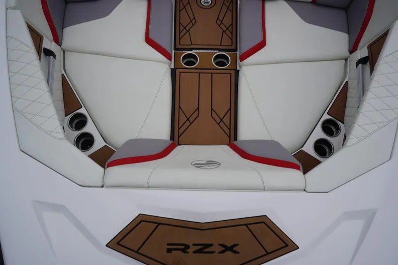Slide: The Image of 2022 Tigé 22RZX boat interior with white, red, and gray seating, featuring cup holders. - 37