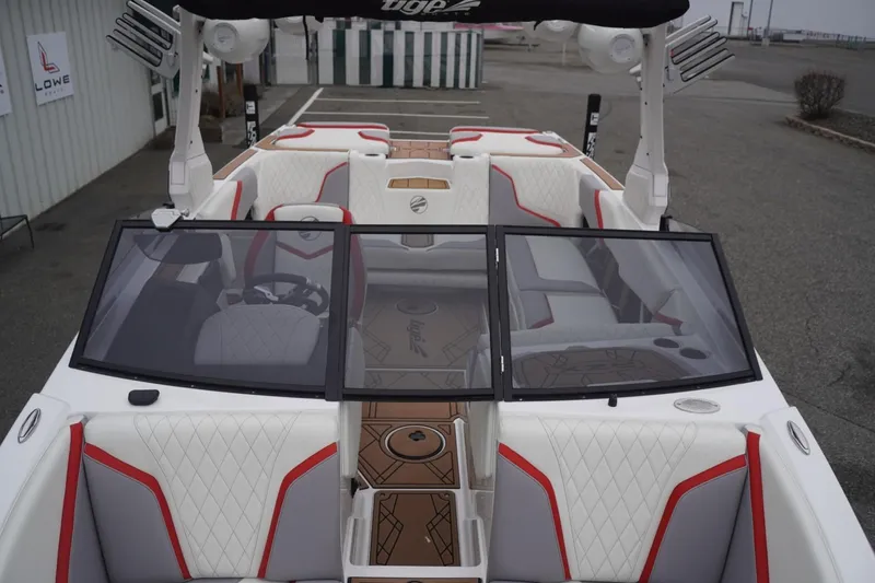 Slide: The Image of 2022 Tigé 22RZX boat interior with white and red seating, windshield, and steering wheel. - 40