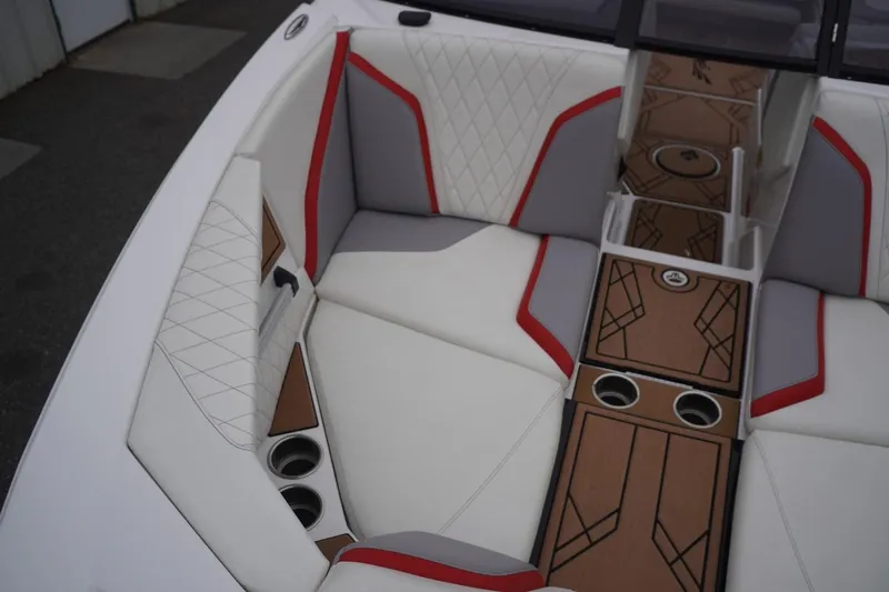Slide: The Image of 2022 Tigé 22RZX boat interior with white, red, and gray upholstery, featuring cup holders and stylish flooring. - 42