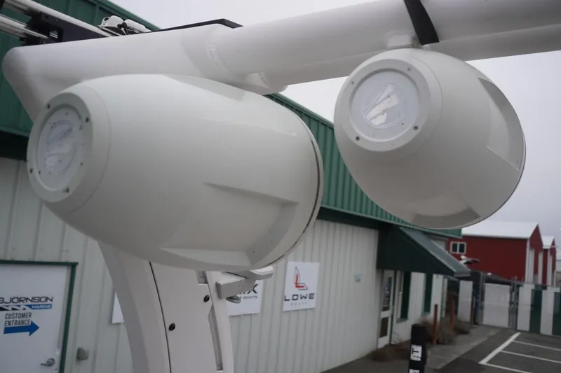 Slide: The Image of Speakers on a 2022 Tigé 22RZX boat, outside a marine shop. - 46