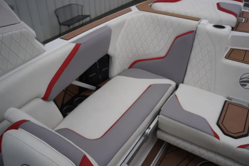 Slide: The Image of 2022 Tigé 22RZX boat interior with white, gray, and red quilted seating. - 47