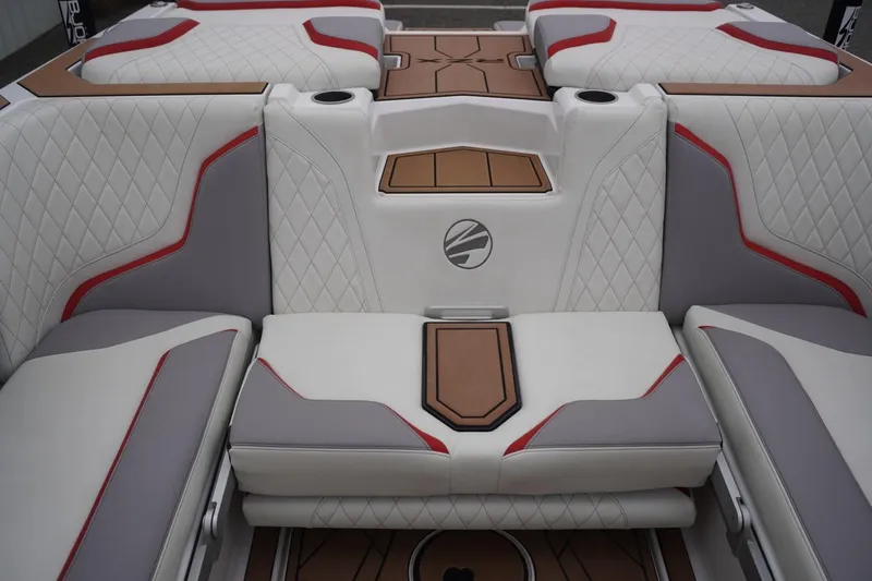 Slide: The Image of Luxurious interior of 2022 Tigé 22RZX boat with quilted seats and red accents. - 48