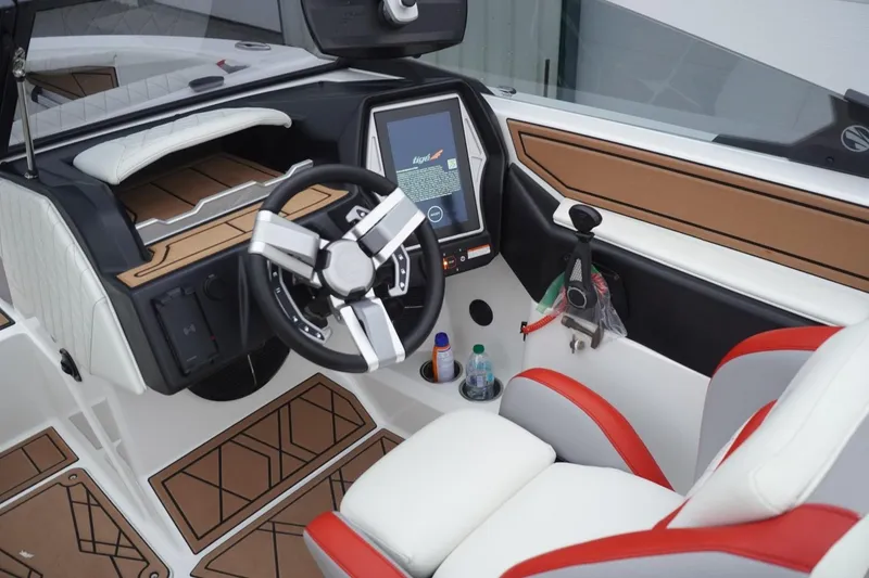 Slide: The Image of 2022 Tigé 22RZX boat interior with modern dashboard and steering wheel. - 50