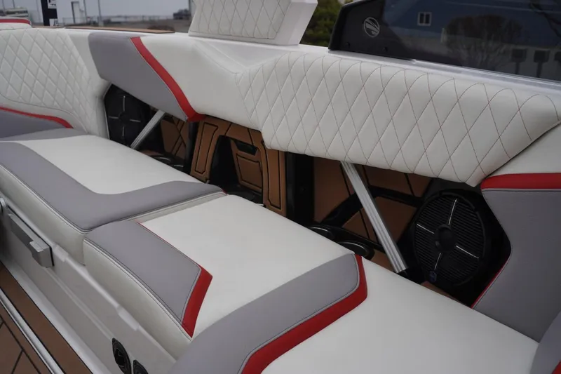 Slide: The Image of 2022 Tigé 22RZX boat interior with white, gray, and red upholstery, featuring diamond stitching. - 52