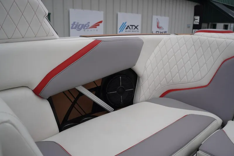 Slide: The Image of 2022 Tigé 22RZX boat interior with white and red upholstery, featuring diamond stitching. - 53