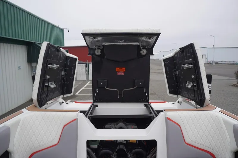 Slide: The Image of 2022 Tigé 22RZX boat with open engine compartment, showcasing interior design and storage. - 55