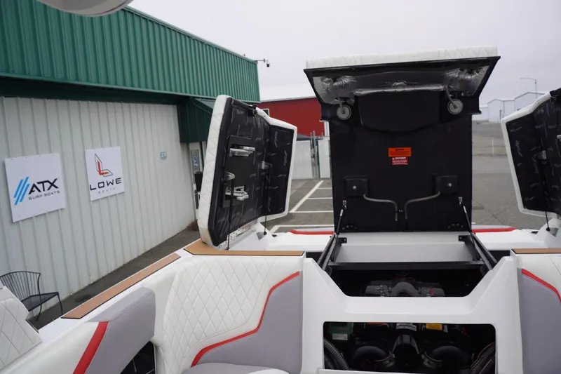 Slide: The Image of 2022 Tigé 22RZX boat engine compartment open at a dealership. - 56