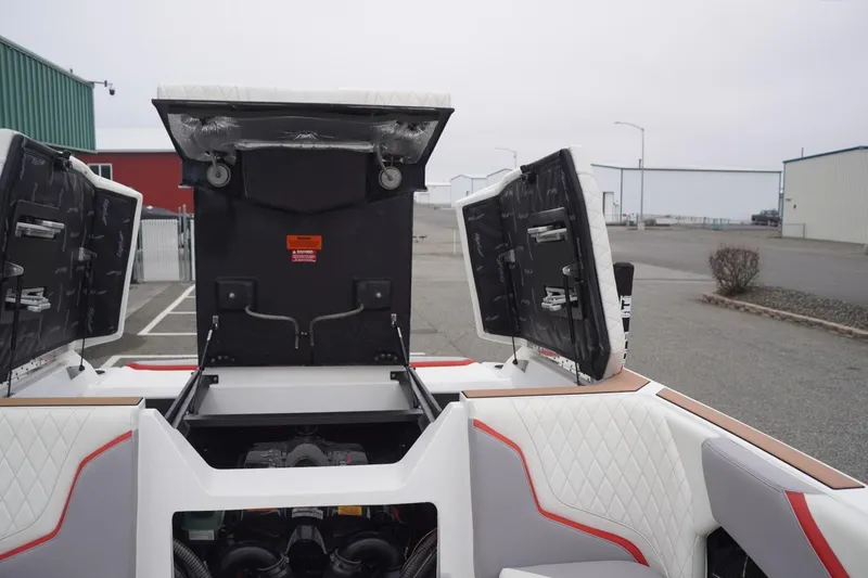 Slide: The Image of 2022 Tigé 22RZX boat engine compartment with open hatches, showcasing interior design. - 57