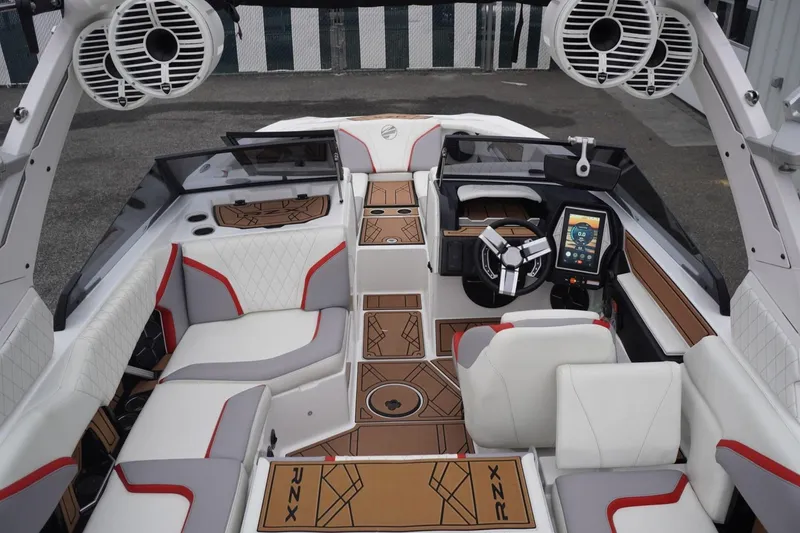 Slide: The Image of 2022 Tigé 22RZX boat interior with modern dashboard, luxury seating, and advanced sound system. - 60