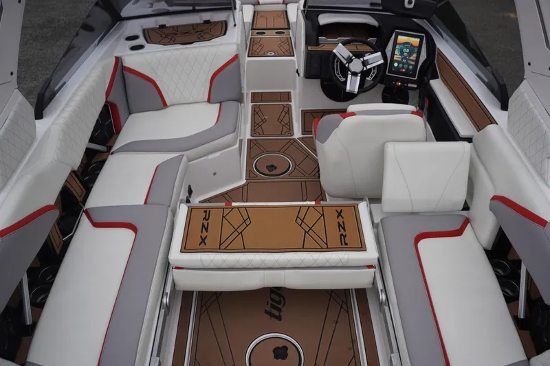 Slide: The Image of 2022 Tigé 22RZX boat interior with luxurious seating and advanced dashboard controls. - 61