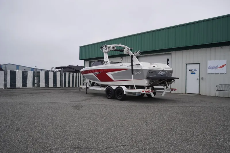 Slide: The Image of 2022 Tigé 22RZX boat on trailer outside a building. - 63