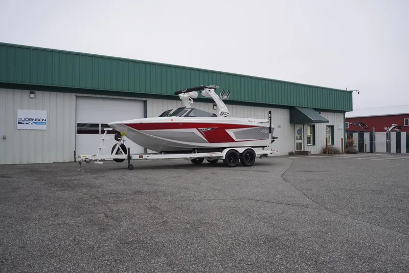 Slide: The Image of 2022 Tigé 22RZX boat on trailer outside Bjornson Marine building. - 66