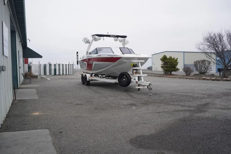 Slide: The Image of 2022 Tigé 22RZX boat on trailer in industrial parking lot. - 68