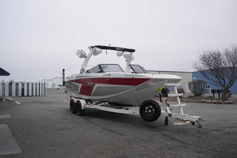 Slide: The Image of 2022 Tigé 22RZX boat on trailer in parking lot, overcast sky. - 73
