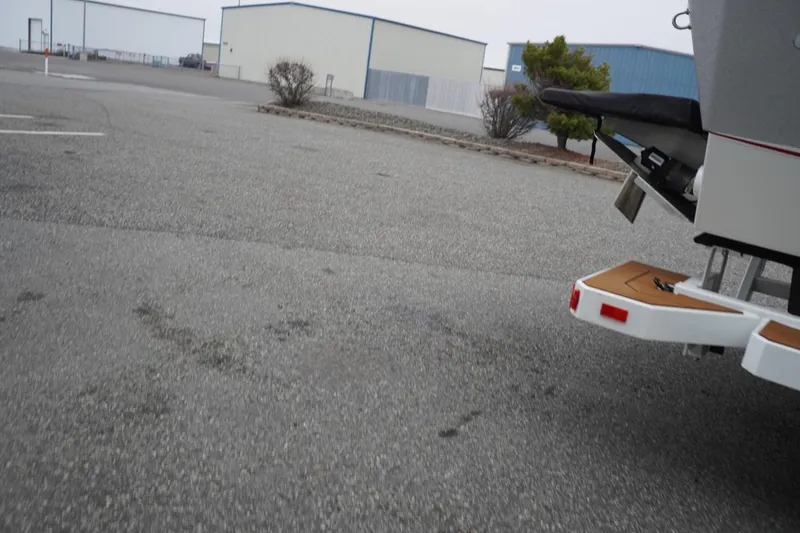Slide: The Image of Partial view of a 2022 Tigé 22RZX boat in a parking lot. - 74