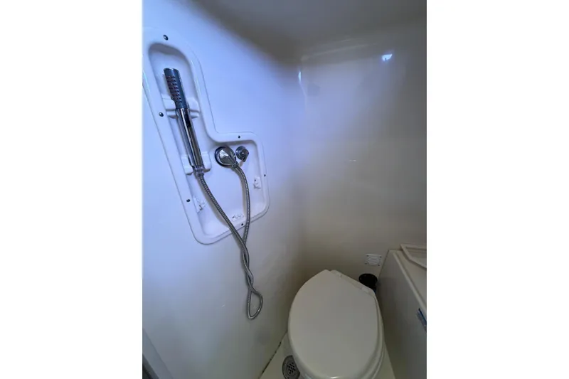 Slide: The Image of Bathroom interior of 2012 Boston Whaler 345 Conquest boat, featuring shower and toilet. - 12