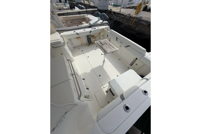 Slide: The Image of 2012 Boston Whaler 345 Conquest boat deck with seating and table. - 2