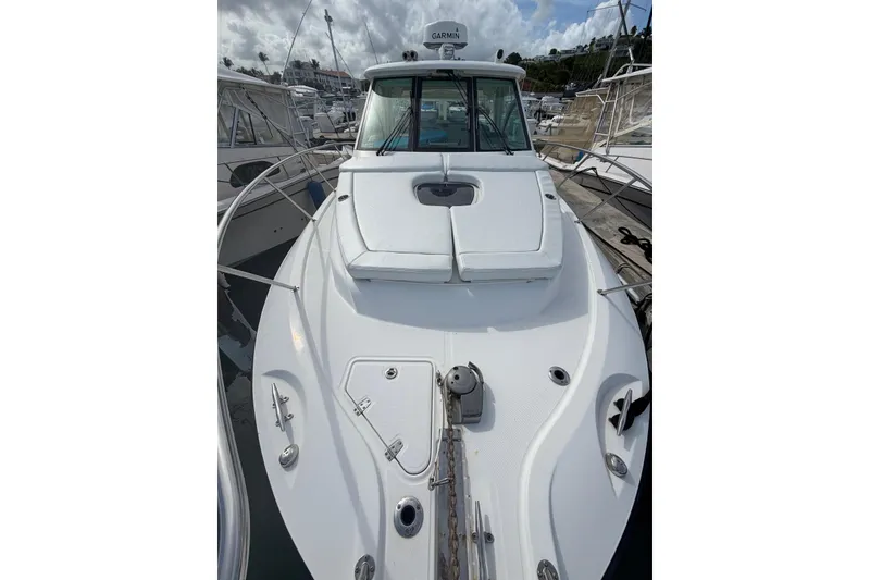 Slide: The Image of 2012 Boston Whaler 345 Conquest boat docked, showcasing sleek design and spacious deck. - 3