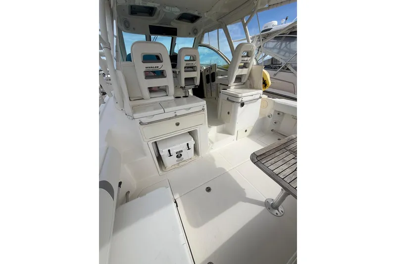 Slide: The Image of 2012 Boston Whaler 345 Conquest interior with seating and storage compartments. - 4