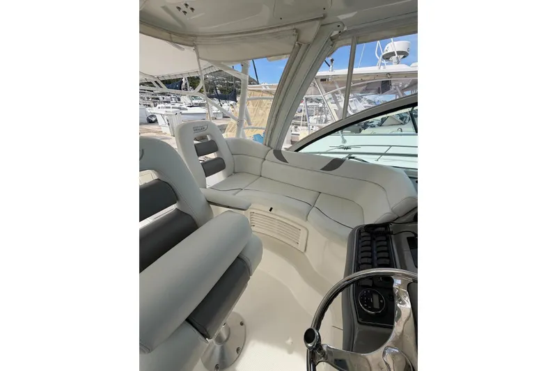Slide: The Image of Interior of 2012 Boston Whaler 345 Conquest boat, featuring plush seating and helm controls. - 6