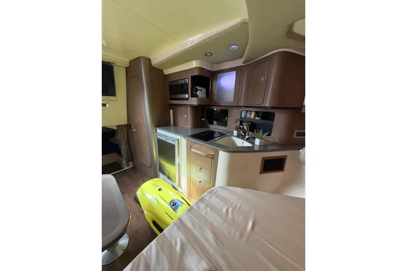 Slide: The Image of Interior of 2012 Boston Whaler 345 Conquest, featuring a compact kitchen area. - 9