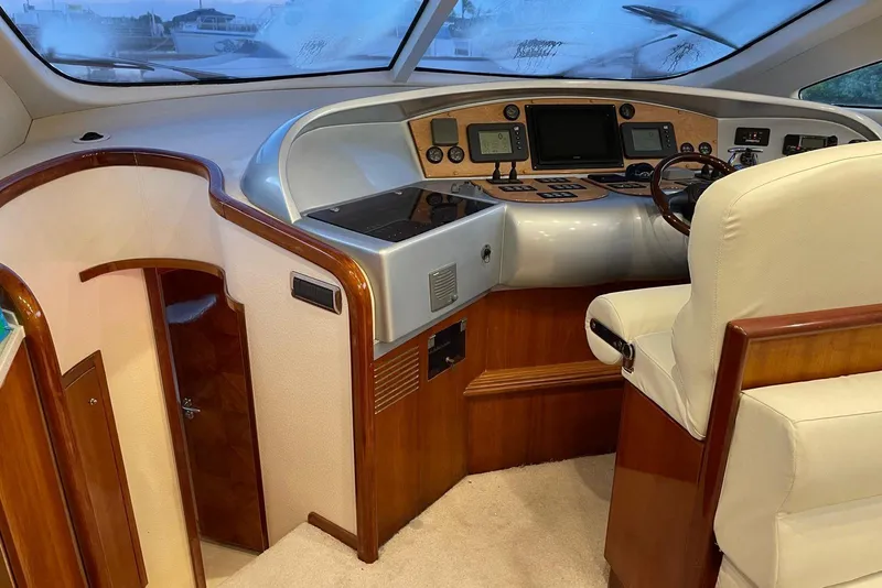 Slide: The Image of Luxury yacht helm of 2007 Aicon 56 with modern controls and plush seating. - 7
