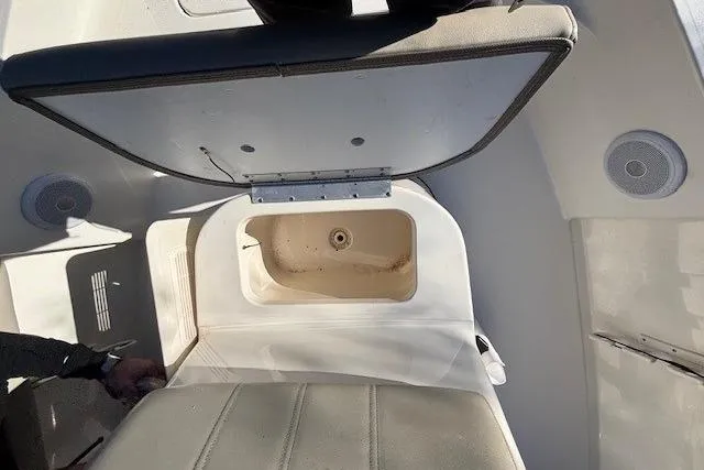 Slide: The Image of 2021 Key West 188 Bay Reef boat interior with open storage compartment. - 21