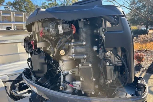 Slide: The Image of 2021 Key West 188 Bay Reef boat with open hatch, parked near a Tundra truck. - 24