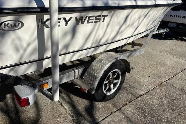 Slide: The Image of Trailer wheel of 2021 Key West 188 Bay Reef on concrete pavement. - 26