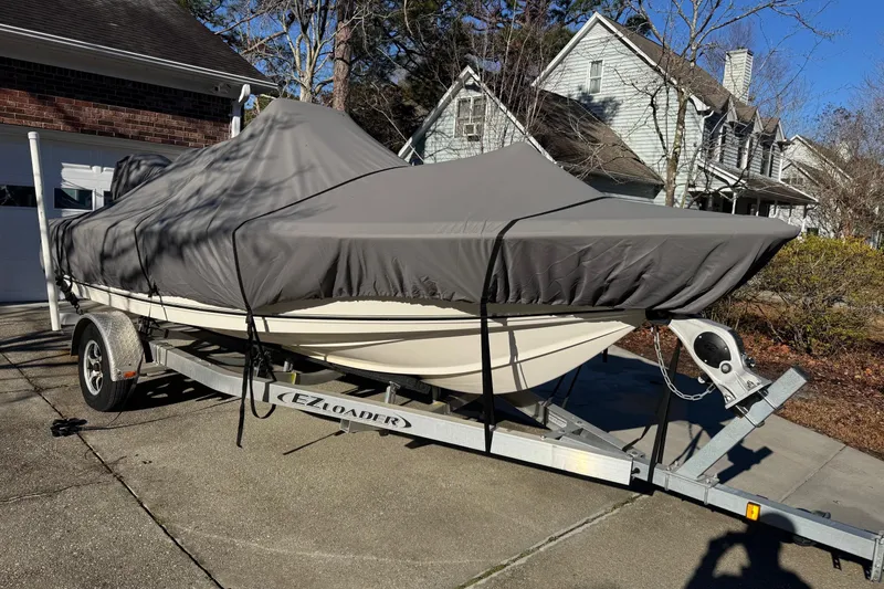 Slide: The Image of 2021 Key West 188 Bay Reef boat covered on trailer in residential driveway. - 29