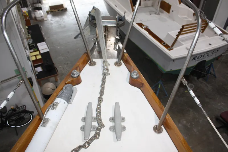Slide: The Image of Bow of a 1981 Bristol 40 sailboat with anchor and chain in a workshop. - 12