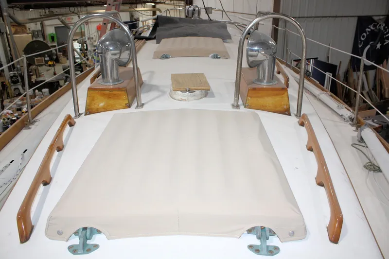 Slide: The Image of 1981 Bristol 40 yacht deck with winches and wooden handrails in a workshop setting. - 15