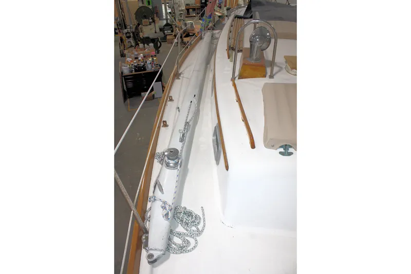 Slide: The Image of 1981 Bristol 40 sailboat deck with winch and ropes in a workshop setting. - 16