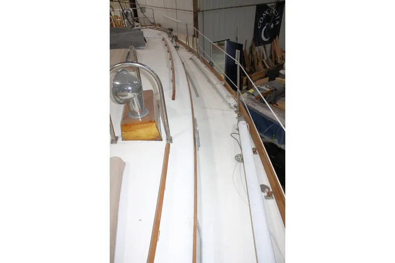 Slide: The Image of 1981 Bristol 40 sailboat deck with polished metal fixtures in a workshop. - 17