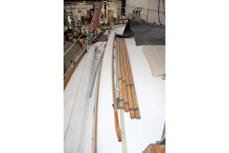 Slide: The Image of 1981 Bristol 40 sailboat deck with wooden poles in a workshop setting. - 19