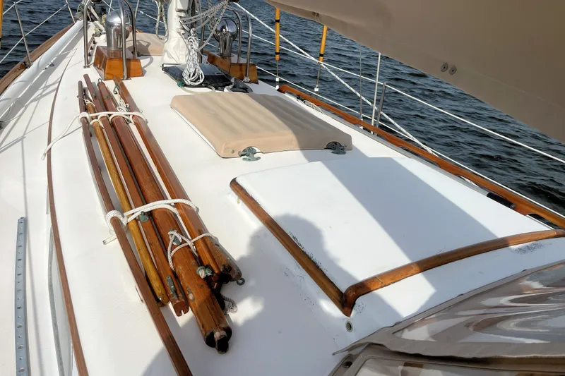 Slide: The Image of 1981 Bristol 40 sailboat deck with wooden details and ropes, sailing on water. - 2
