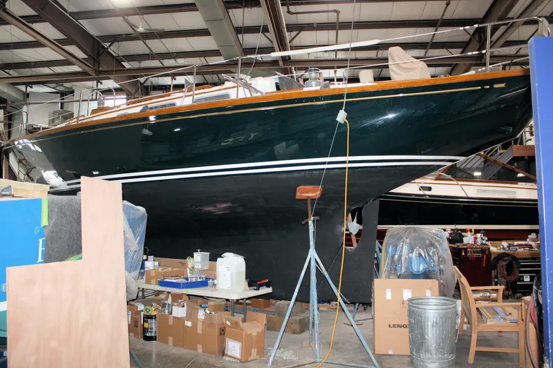 Slide: The Image of 1981 Bristol 40 sailboat deck with wooden details and ropes, sailing on water. - 21