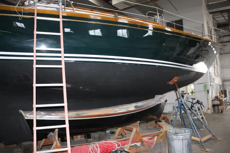 Slide: The Image of Cozy cabin interior of 1981 Bristol 40 sailboat with wooden finish and green cushions. - 25