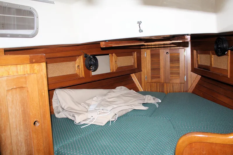 Slide: The Image of 1981 Bristol 40 yacht cabin interior with wooden finish and green bedding. - 26