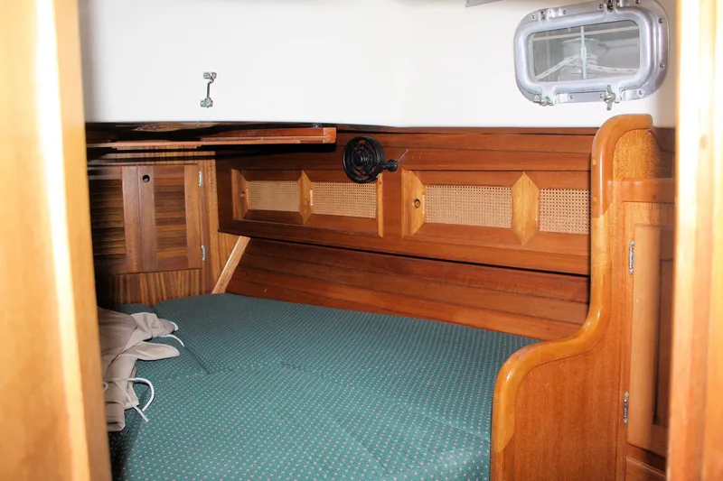 Slide: The Image of 1981 Bristol 40 yacht interior with wooden paneling and cozy sleeping area. - 28